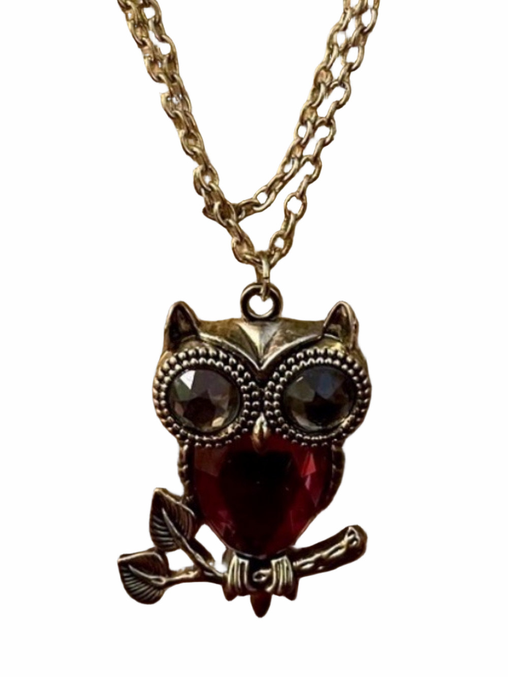 Striking owl pendant with silver and gemstones on necklace.